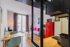 uma cozinha e sala de estar com um frigorífico vermelho em Le Boz'art em Montpellier