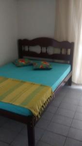 a bed sitting in a room with a blue mattress at Casa Praia do Forte in Cabo Frio