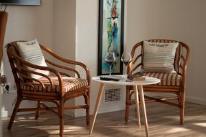 two chairs and a table with a wine glass on it at Belado Residence Bol in Bol