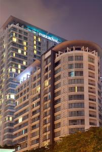 a large building with a clock on top of it at PARKROYAL Serviced Suites Kuala Lumpur in Kuala Lumpur