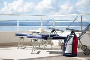 a table and chair on a balcony with the ocean at Belado Residence Bol in Bol