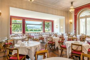 een eetkamer met witte tafels en stoelen bij Grand Hotel Europe in Luzern