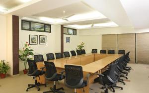 a large conference room with a long table and chairs at Ahuja Residency Parklane, Gurgaon in Gurgaon