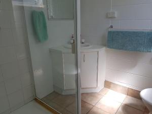 a bathroom with a shower and a sink at Apurla Island Retreat in K'gari Island (Fraser Island)