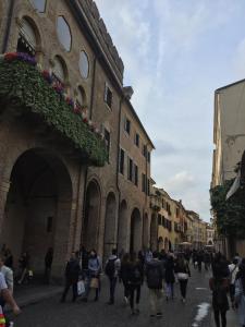 a group of people walking down a street next to a building at ApartmentsPadova in Padova