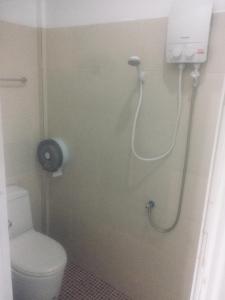 a small bathroom with a toilet and a shower at Hero Phuket in Nai Yang Beach