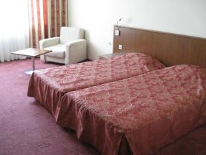 En eller flere senger på et rom på Hotel Elegance