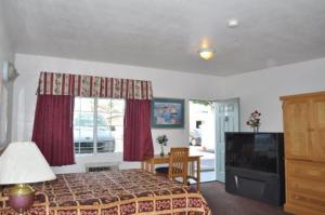 a bedroom with a bed and a television in it at The Palace Inn in Oxnard