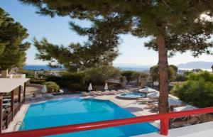 a swimming pool with a view of the ocean at Pefkos Filoxenia in Pefki