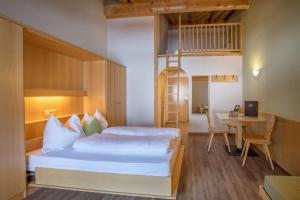a bedroom with a bed and a desk and a loft bed at Mountain Living Apartments in San Valentino alla Muta +133 photos