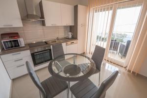 a kitchen with a glass table and chairs in it at Villa Karamba in Senj