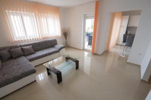 a living room with a couch and a table at Villa Karamba in Senj