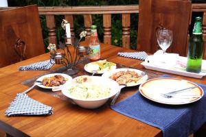 einem Holztisch mit Teller mit Lebensmitteln darauf in der Unterkunft Suzzi Villa in Weligama