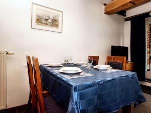 a table with a blue table cloth on it at Nice apartments in a monumental square farm in Richelle