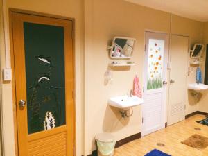 a small bathroom with a sink and a toilet at Anya House in Thongsala