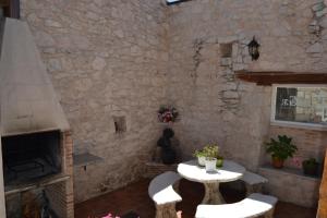 a stone room with a table and a fireplace at El Lagar in Canalejas de Peñafiel