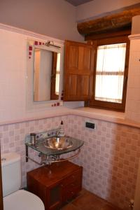 a bathroom with a sink and a toilet at El Lagar in Canalejas de Peñafiel +57 photos