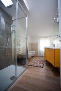 a bathroom with a shower and a sink and a tub at Residence Torino in Chioggia +5 photos