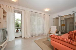 a living room with a couch and a television at Ferienwohnung Pali in Sankt Johann in Tirol
