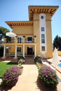 
a large white house with a large window at Hotel Boutique Villa Lorena by Charming Stay in Málaga
