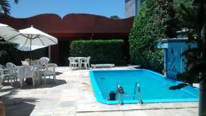 a person is playing in a swimming pool at Pousada Trevo do Porto in Porto Seguro