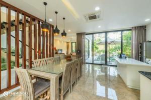 cocina y comedor con mesa y sillas en Flamingo Dailai - HQ villa, en Ngọc Quang