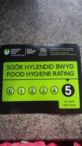a yellow sign on a food hygiene rating box at Cherryberry Lodges in Abergavenny