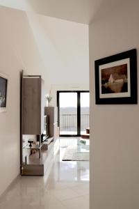 a living room with white walls and a large window at Appartement T4 Vue Unique in Rodez