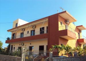 a building with a fence in front of it at Villa Shpetim Zogaj. in Ksamil