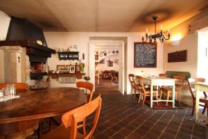 a kitchen and dining room with a table and chairs at Penzion V polích in Malé Číčovice
