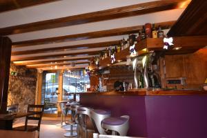 a bar with a bunch of bottles on the wall at Hotel Micolau in Arinsal