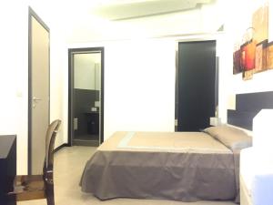 a bedroom with a bed and a chair and a mirror at Residenza Santa Lù B&B in Naples