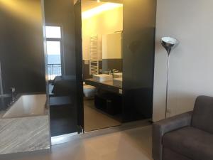 a bathroom with a mirror and a sink and a couch at Residenza Santa Lù B&B in Naples +19 photos