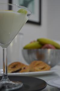 a glass of white wine next to a plate of fruit at Villa Alba Boutique Hotel in Pescara