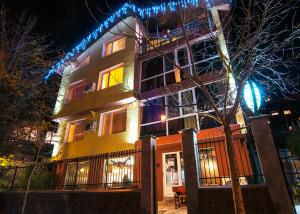 a building with christmas lights on top of it at Hotel Zara Rooms in Stara Zagora