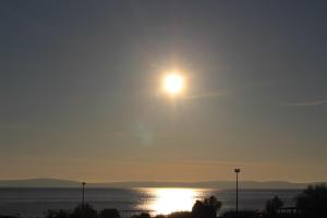 a sun setting over a body of water at Apartments Blue Maris Žnjan in Split