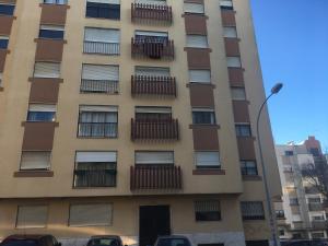 a tall building with balconies on the side of it at APARTAMENTO LISBOA - REBOLEIRA in Amadora