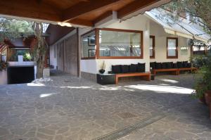 a patio with couches and windows on a building at Villa Alba Boutique Hotel in Pescara