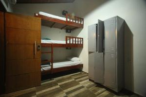 a room with two bunk beds and a locker at Savana Hostel in Sao Jorge