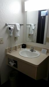 a bathroom with a sink and a mirror at Howard Johnson by Wyndham Billings in Billings +20 photos