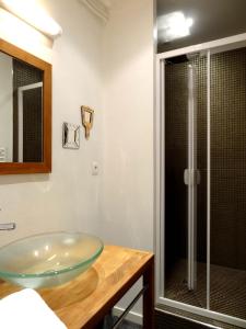 a bathroom with a glass sink and a shower at Les Carmes in Rouen