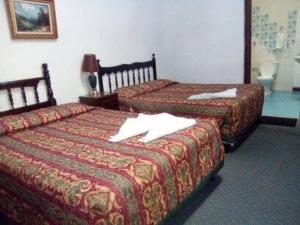 a hotel room with two beds in a room at Hotel Spring in Guatemala