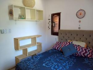 a bedroom with a bed with a blue comforter at Jardin de Estrellas in San Marcos Sierras