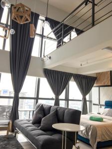 a living room with a couch and a bed at Ginger8 @ Pinnacle PJ in Petaling Jaya