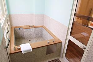 W łazience z przeszklonymi drzwiami znajduje się prysznic. w obiekcie 星月文旅溫泉民宿 w mieście Houli