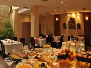 a dining room table filled with food and drinks at Gregorio I Hotel Boutique in San Salvador de Jujuy