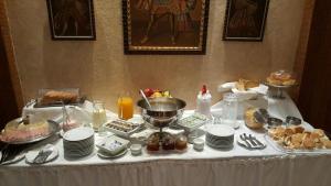 a table with plates of food on it at Gregorio I Hotel Boutique in San Salvador de Jujuy