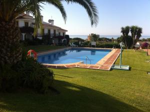 a swimming pool in the yard of a house at Adosado en residencial in Mijas Costa