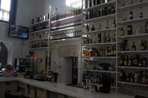 a bar with a lot of bottles of alcohol at Hacienda Requelme Golf Resort Apartment in Sucina