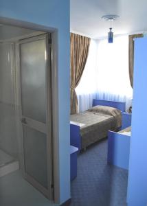 a room with a bed and a window and a door at Hotel 3A in Tirana